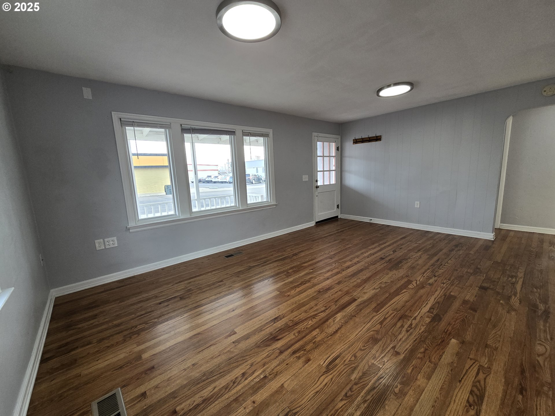 210 Southwest 3rd Street Hermiston, OR 97838 - Photo 13 of 24 a view of an empty room with wooden floor and a window