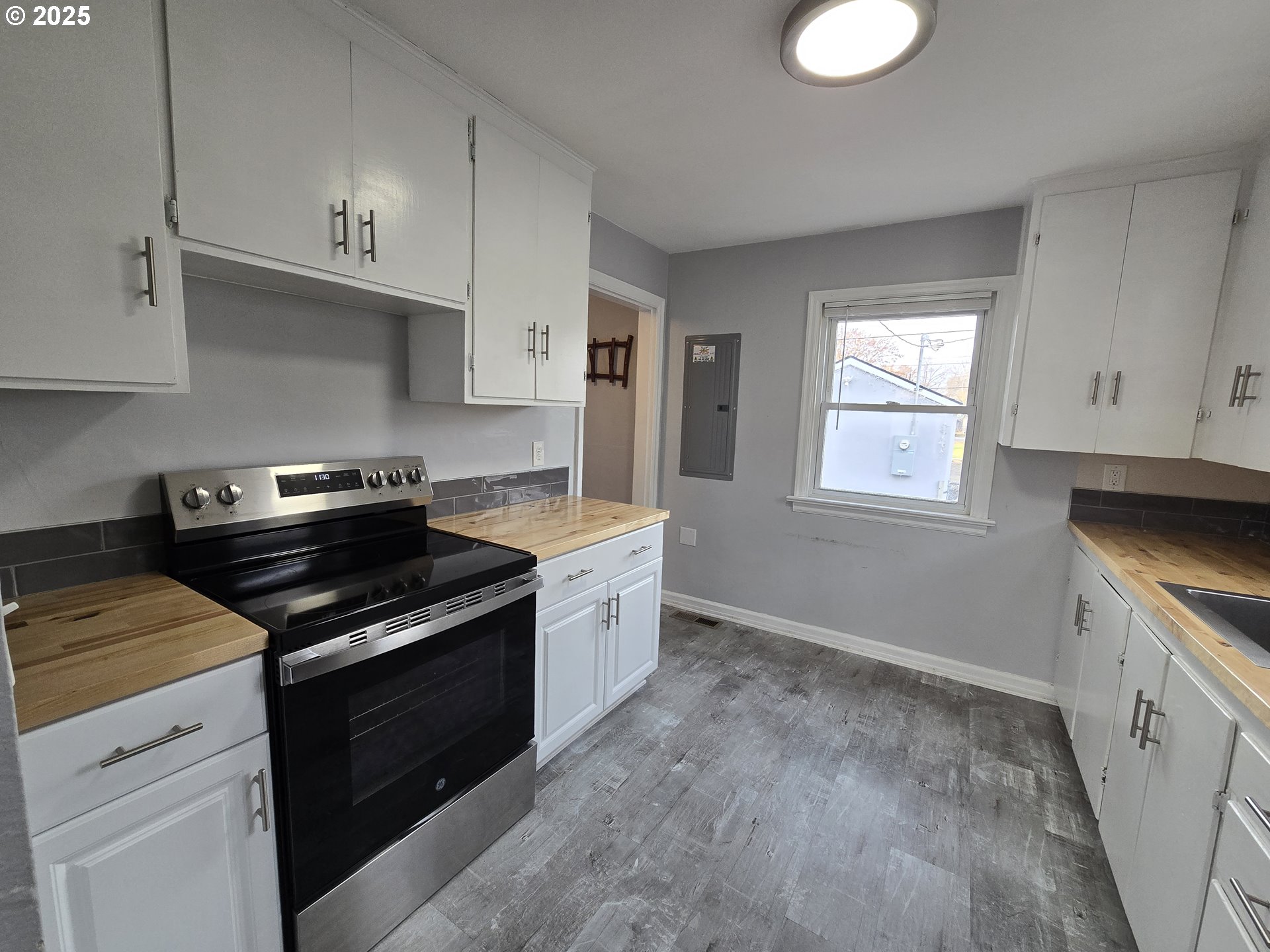 210 Southwest 3rd Street Hermiston, OR 97838 - Photo 14 of 24 a kitchen with a stove and a white cabinets