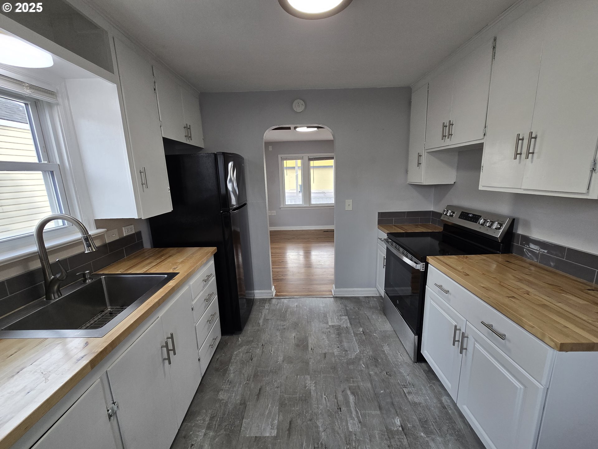 210 Southwest 3rd Street Hermiston, OR 97838 - Photo 18 of 24 a kitchen with a sink stove and refrigerator
