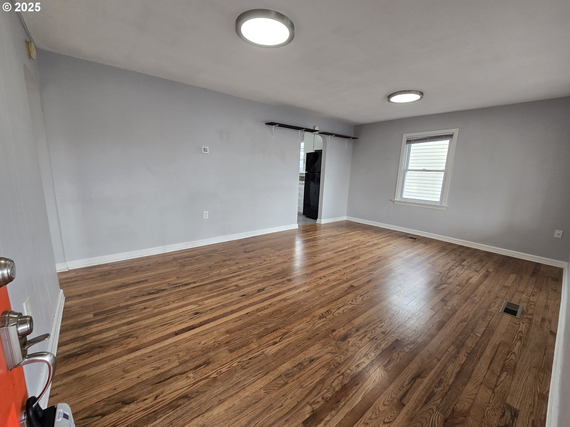 210 Southwest 3rd Street Hermiston, OR 97838 - Photo 10 of 24 an empty room with wooden floor and windows