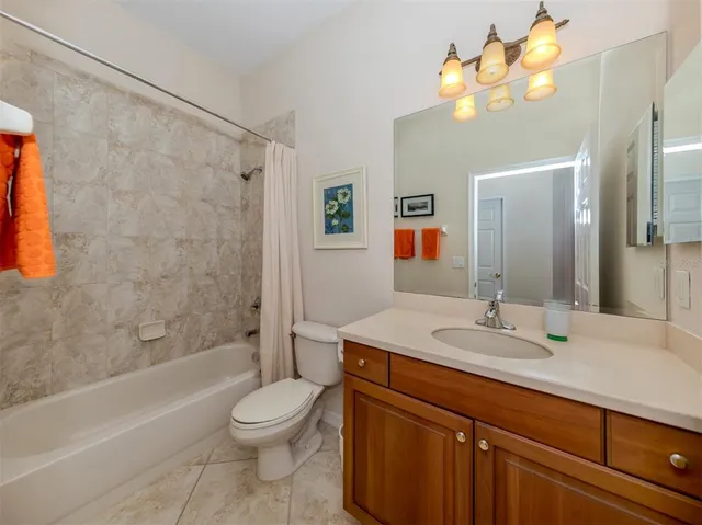 a view of a backyard with a small deck and a garden