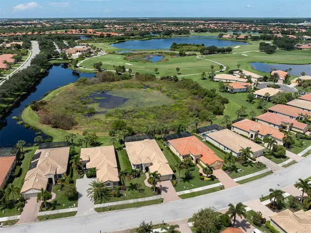 an aerial view of a house with a lake view
