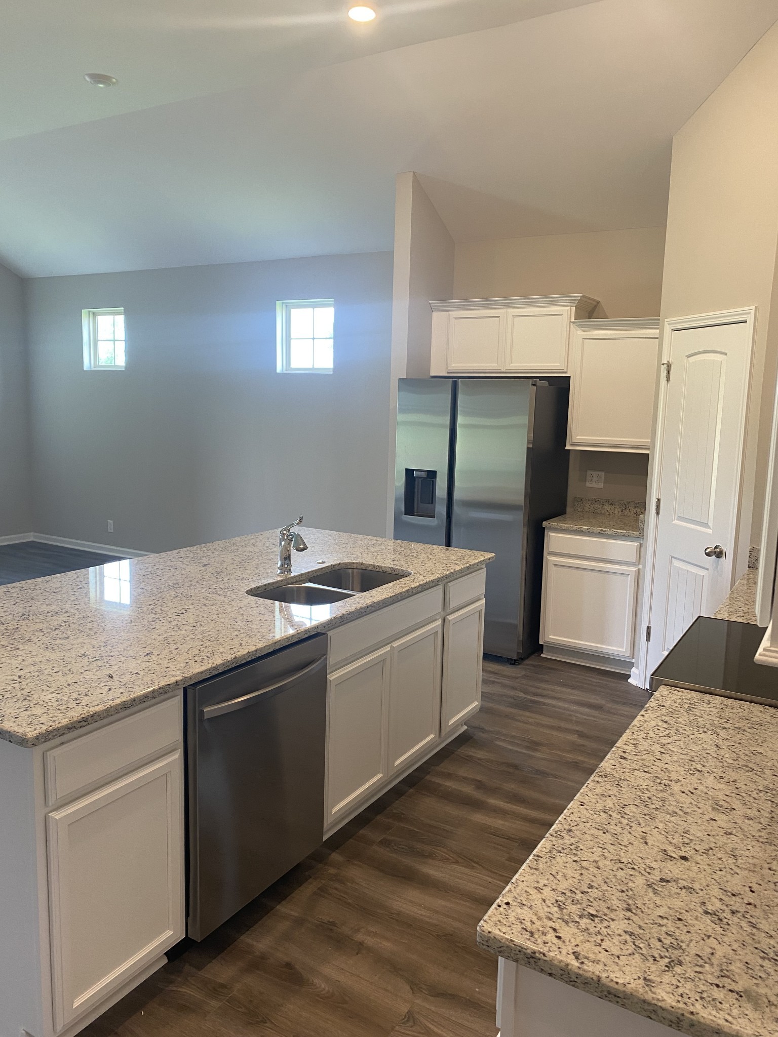 417 Ruby Cate Way Murfreesboro, TN 37128 - Photo 4 of 11 a large kitchen with granite countertop a sink and dishwasher a stove with wooden floors