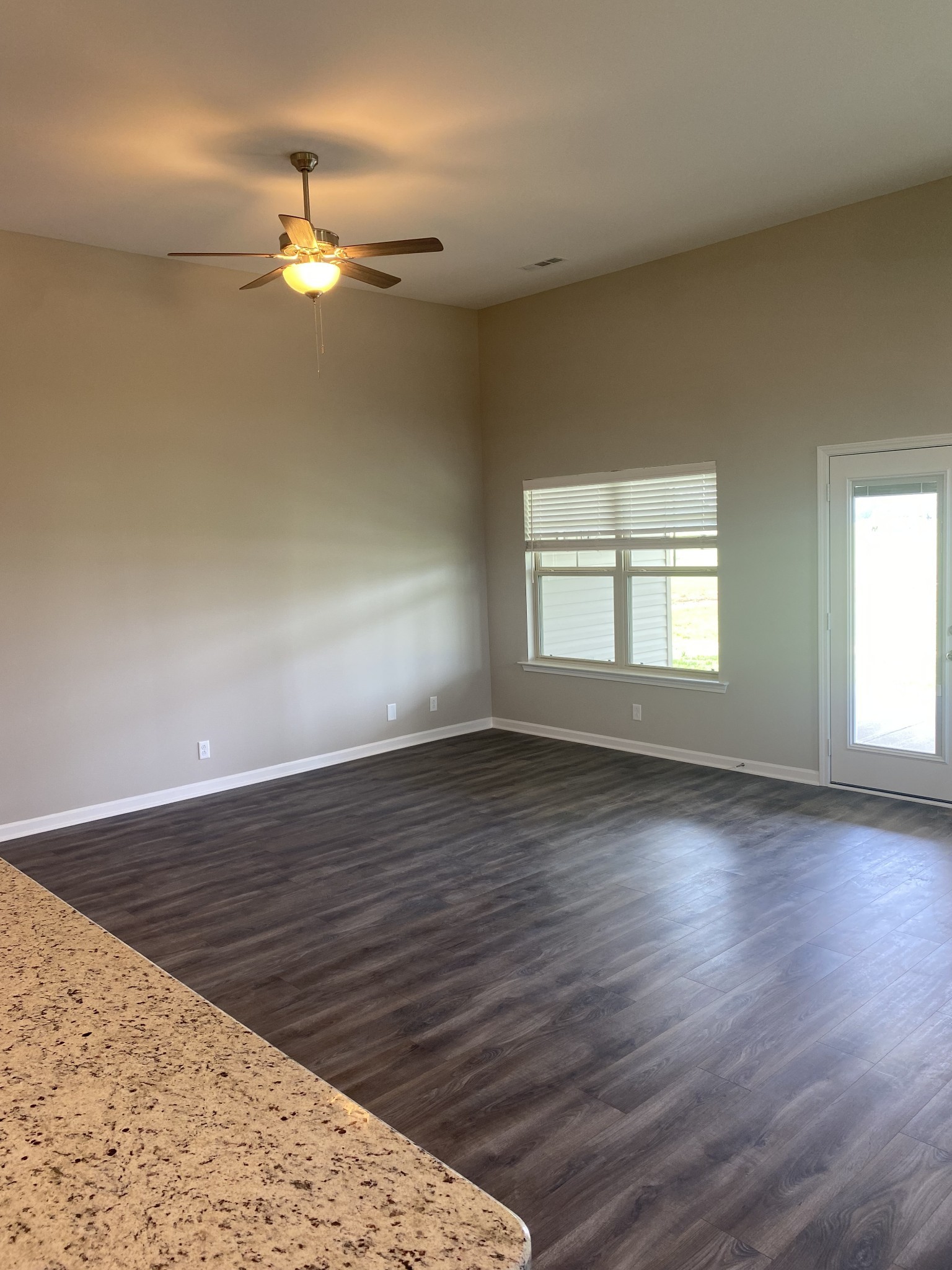 417 Ruby Cate Way Murfreesboro, TN 37128 - Photo 5 of 11 an empty room with wooden floor chandelier fan and windows