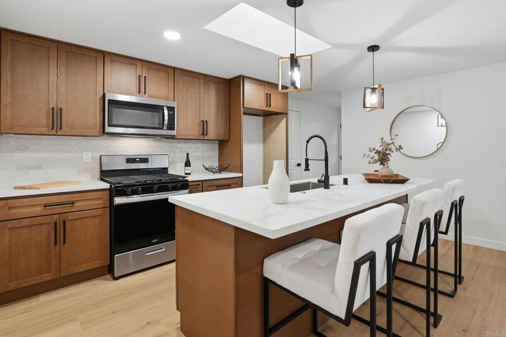 1333 Helix Street Spring Valley, CA 91977 - Photo 12 of 45 a kitchen with a dining table and chairs