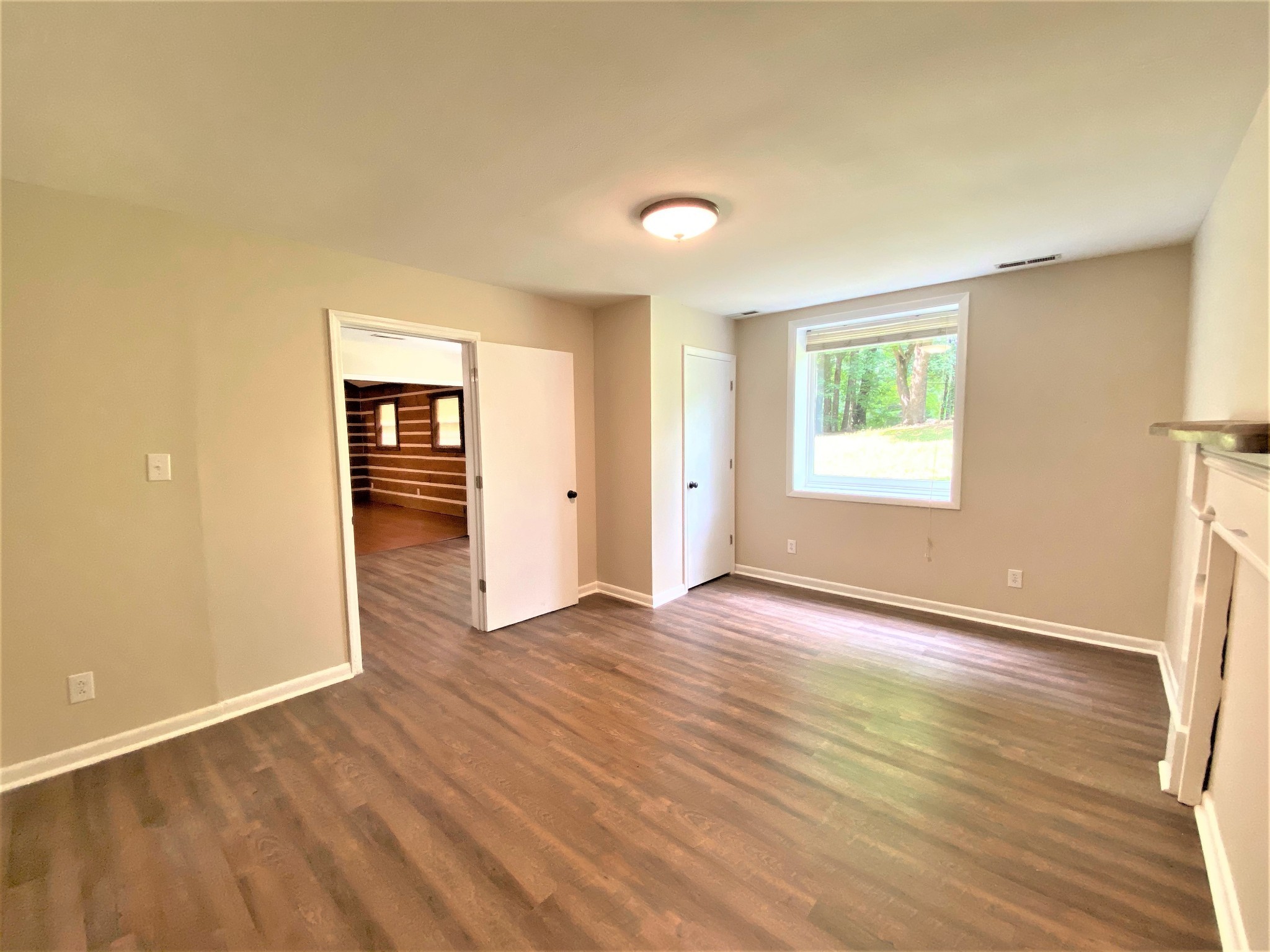 1035 West Point Road Lawrenceburg, TN 38464 - Photo 14 of 42 an empty room with wooden floor and windows