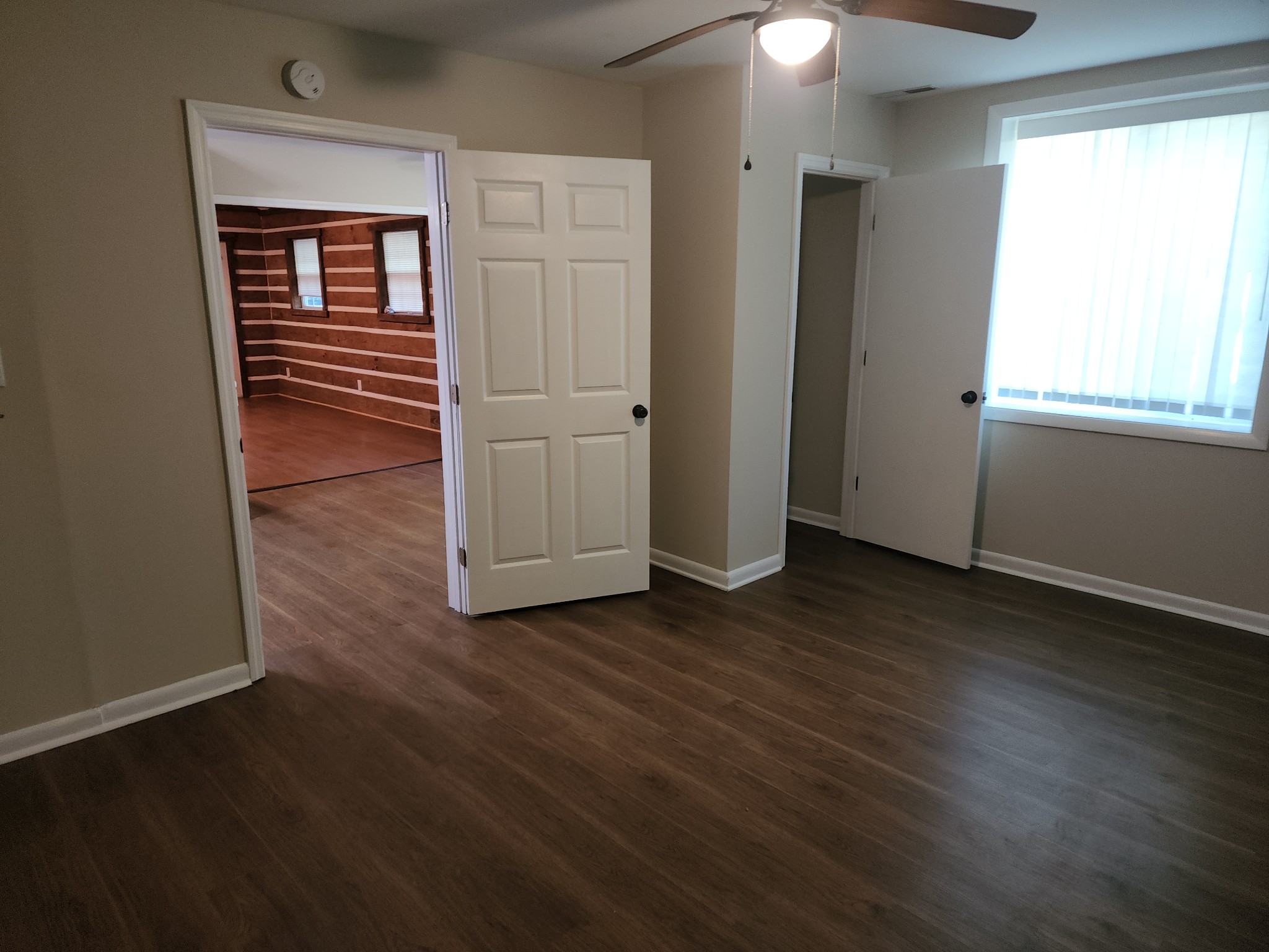 1035 West Point Road Lawrenceburg, TN 38464 - Photo 15 of 42 an empty room with wooden floor cabinet and windows
