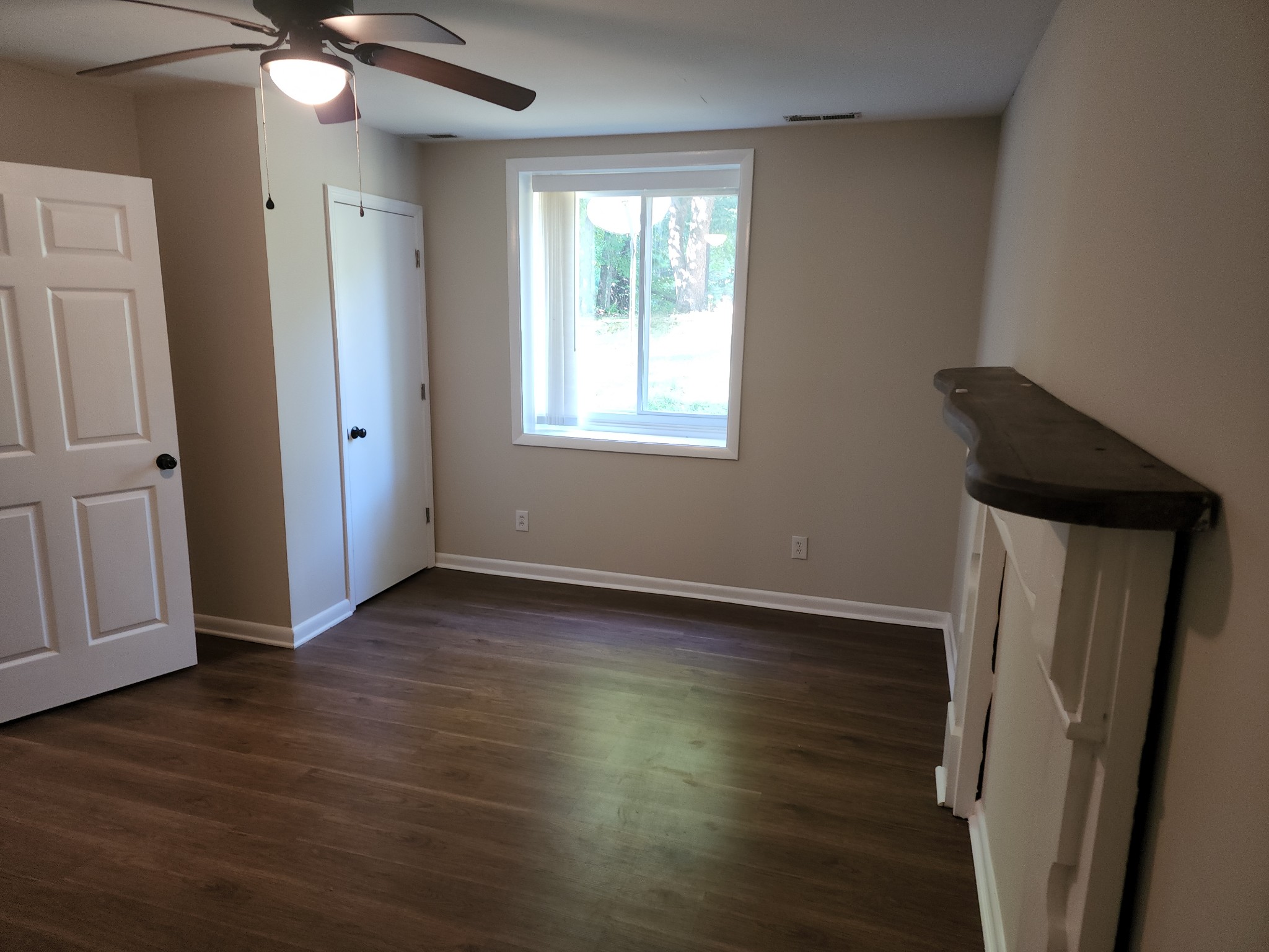1035 West Point Road Lawrenceburg, TN 38464 - Photo 16 of 42 an empty room with wooden floor and windows