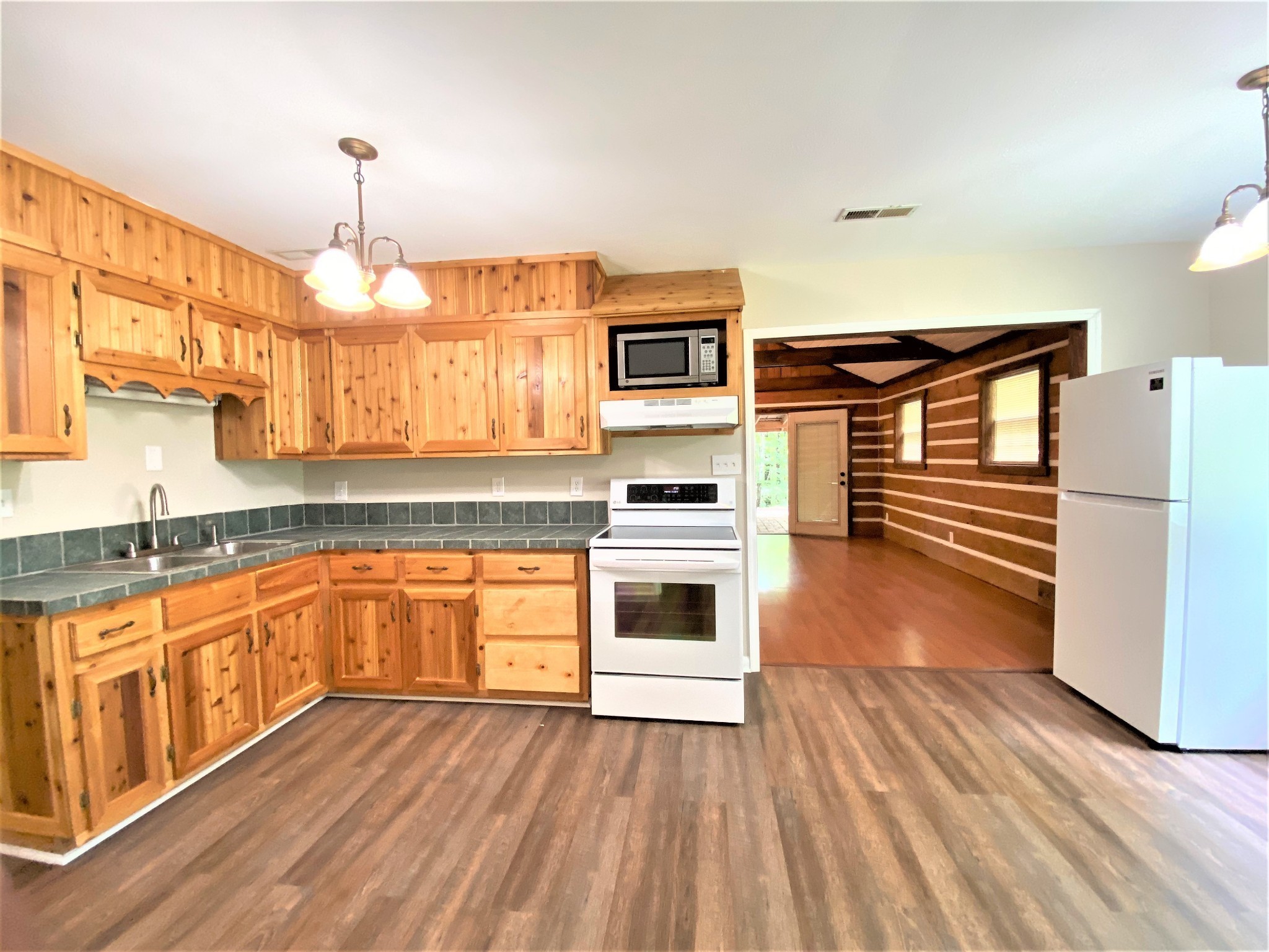 1035 West Point Road Lawrenceburg, TN 38464 - Photo 2 of 42 a kitchen with granite countertop a stove a sink and a refrigerator
