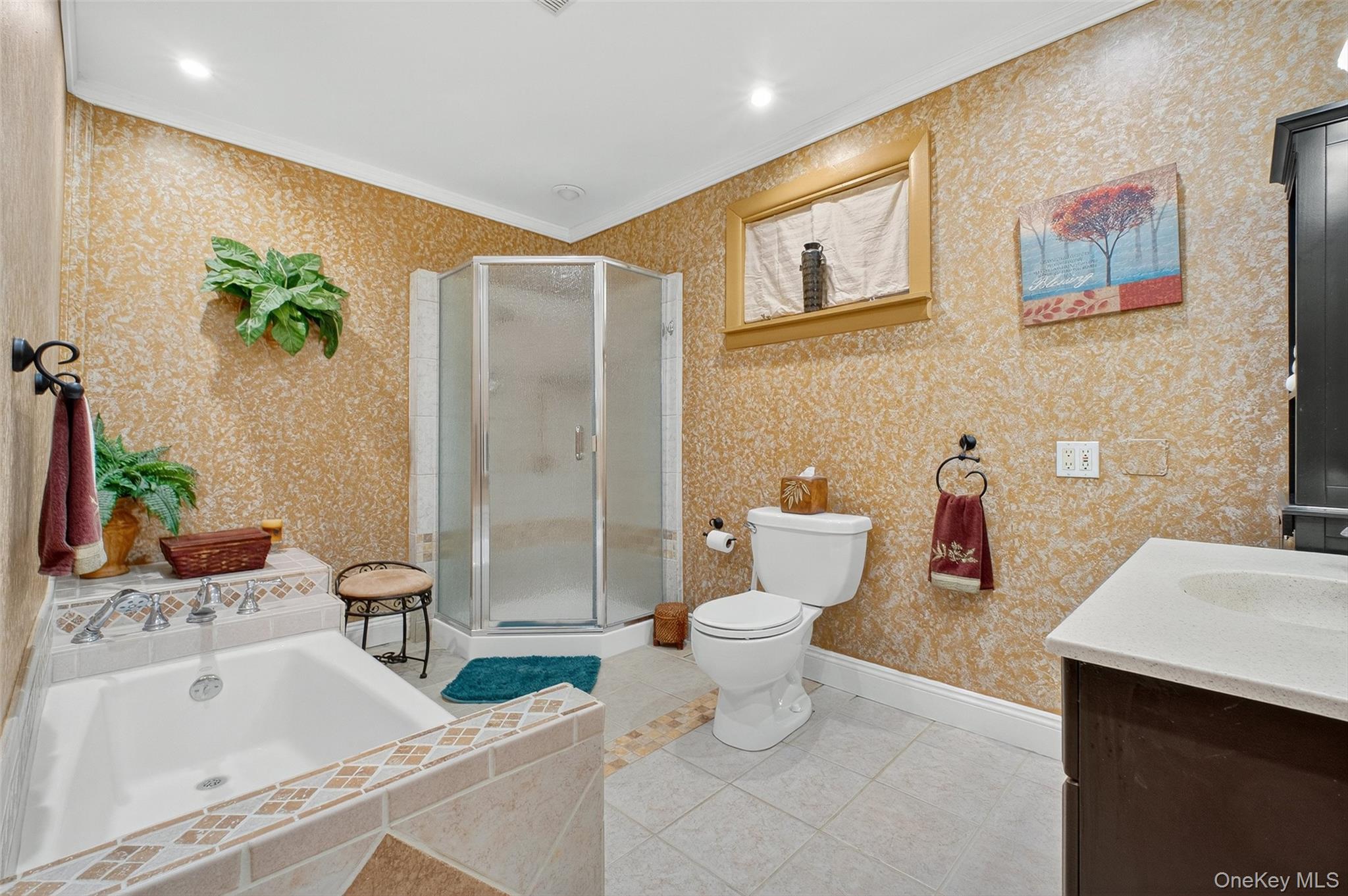 333 Canoe Hill Road Saugerties, NY 12477 - Photo 18 of 34 Bathroom featuring ornamental molding, vanity, a stall shower, light tile patterned flooring, and a garden tub