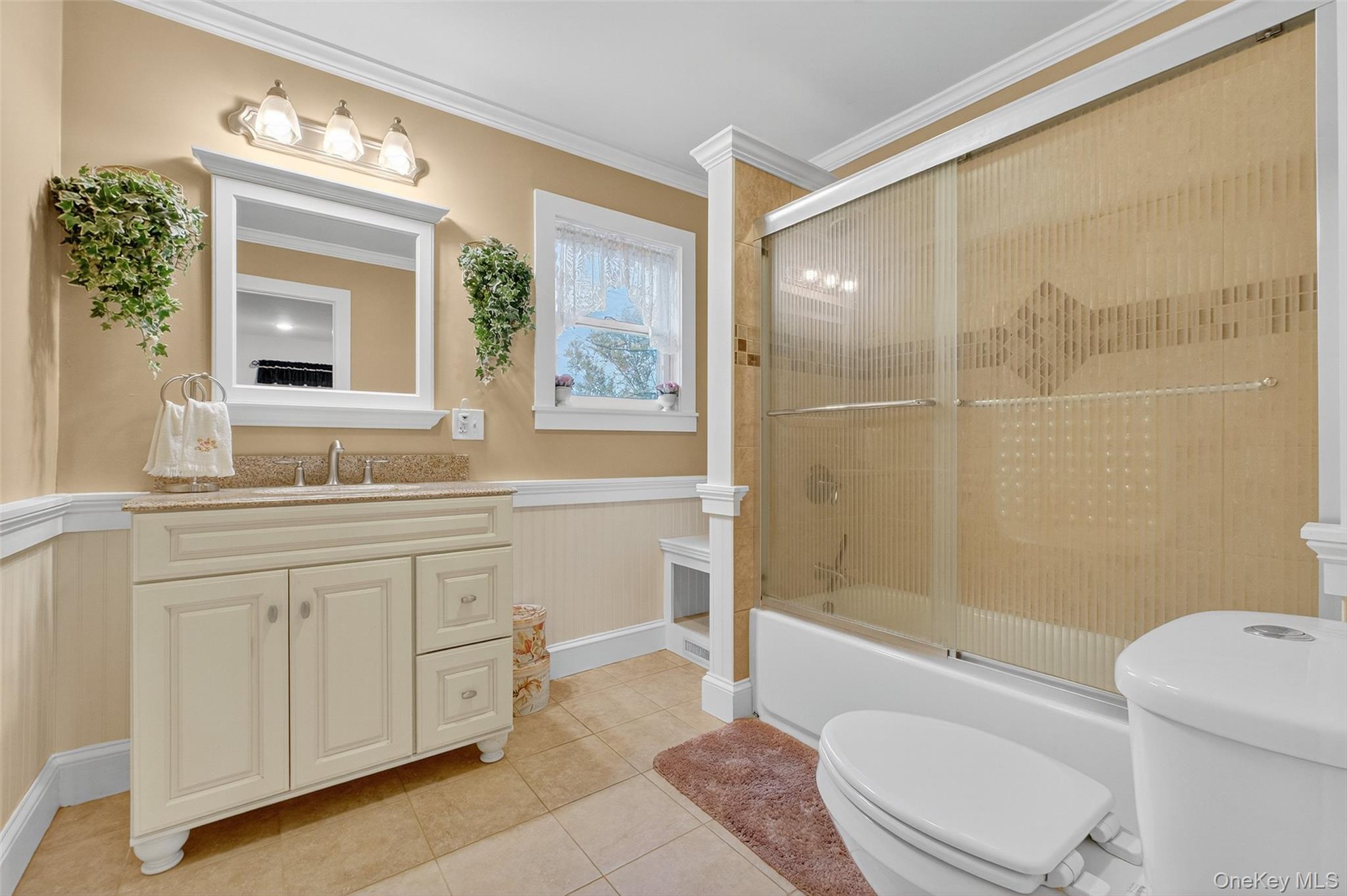 333 Canoe Hill Road Saugerties, NY 12477 - Photo 25 of 34 Full bathroom with a wainscoted wall, crown molding, enclosed tub / shower combo, light tile patterned floors, and vanity