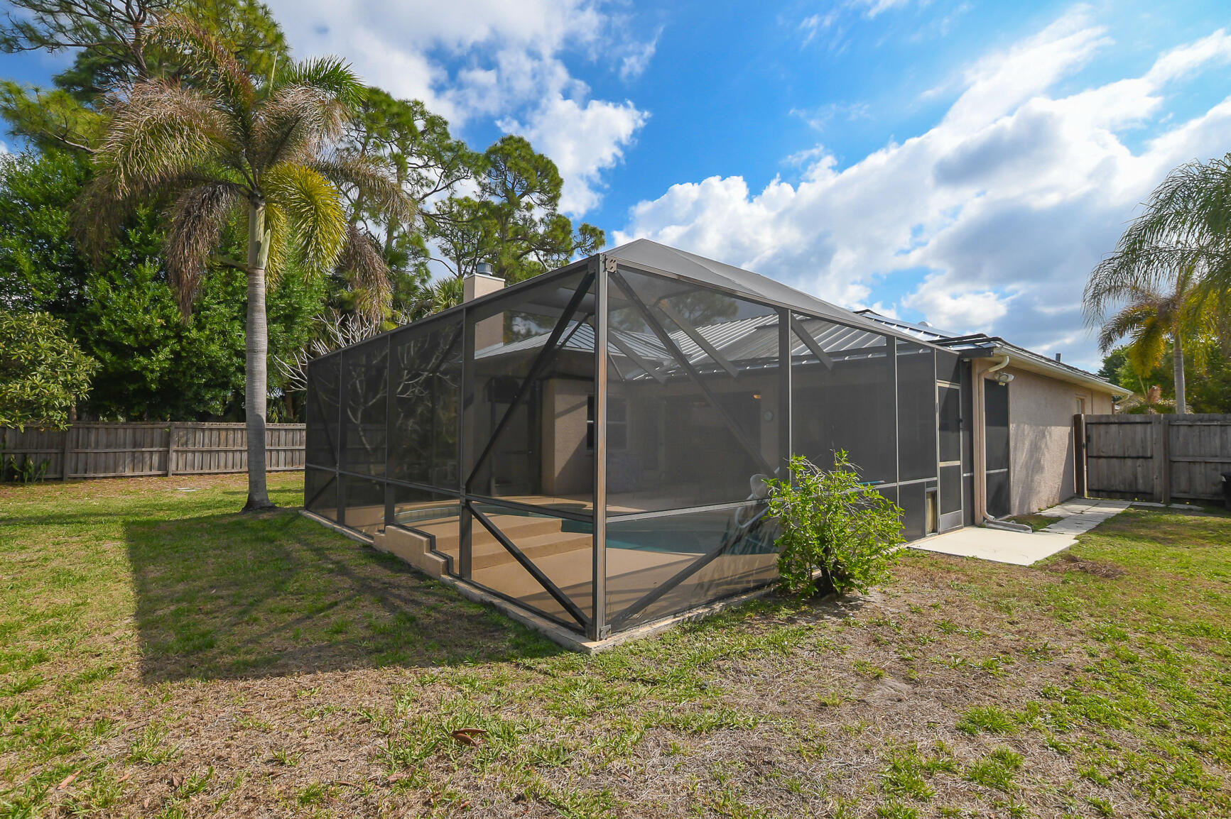 1662 Southwest Rutland Street Port St. Lucie, FL 34987 - Photo 12 of 40 a backyard of a house with table and chairs
