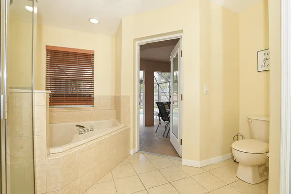 a bathroom with a shower and a glass door