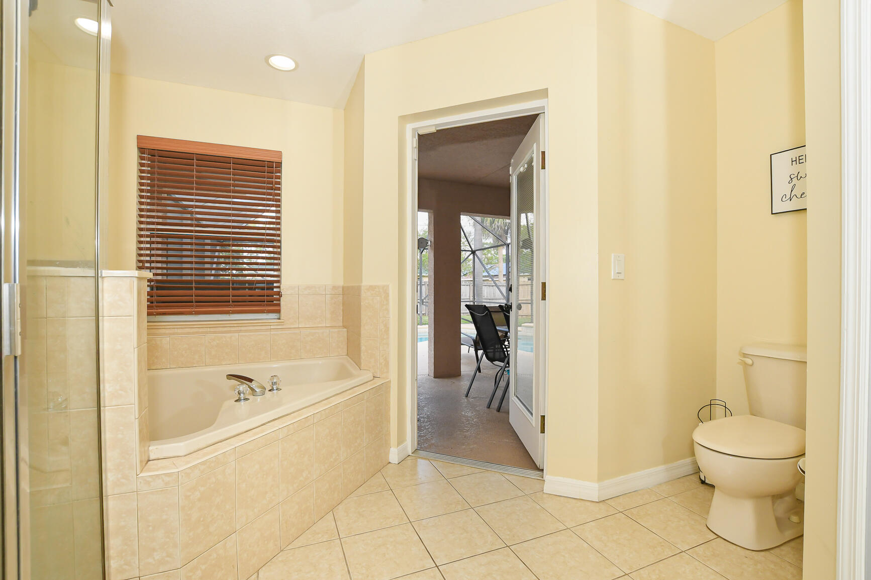 1662 Southwest Rutland Street Port St. Lucie, FL 34987 - Photo 18 of 40 a bathroom with a granite countertop toilet and a bathtub