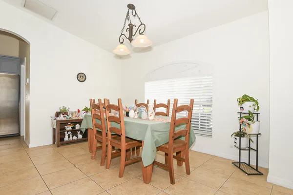a living room with furniture and a dining table