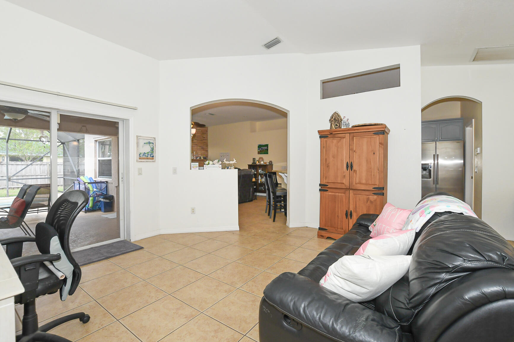 1662 Southwest Rutland Street Port St. Lucie, FL 34987 - Photo 26 of 40 a living room with furniture and a dining table