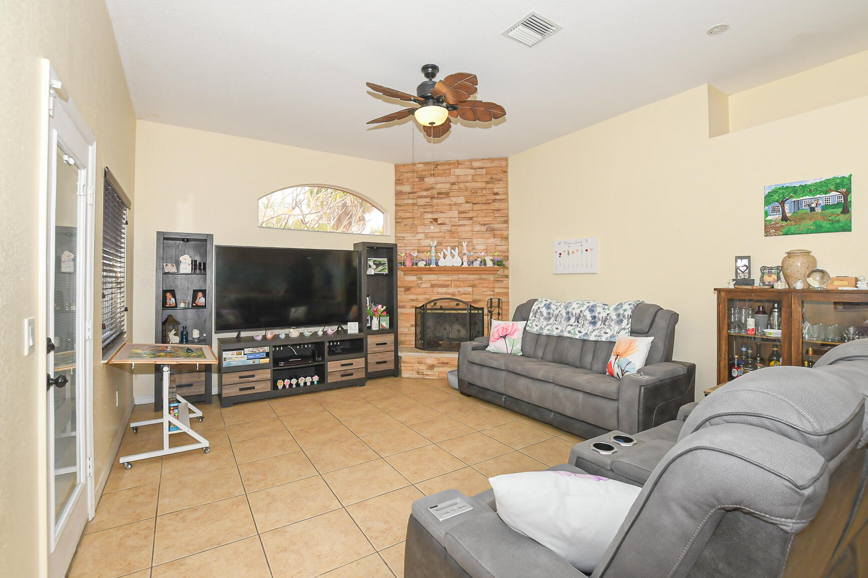 1662 Southwest Rutland Street Port St. Lucie, FL 34987 - Photo 28 of 40 a living room with furniture and a flat screen tv