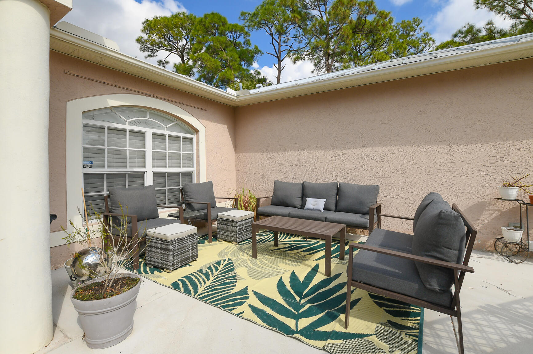 1662 Southwest Rutland Street Port St. Lucie, FL 34987 - Photo 5 of 40 a outdoor living room with furniture and a potted plant