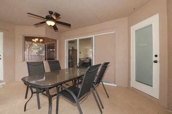 a view of a dining room with furniture and a chandelier