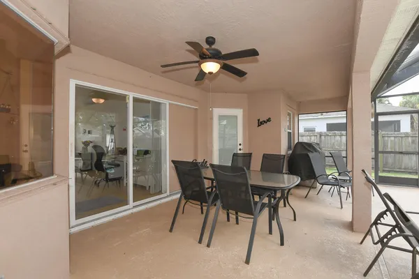 a dining room with furniture and a floor to ceiling window