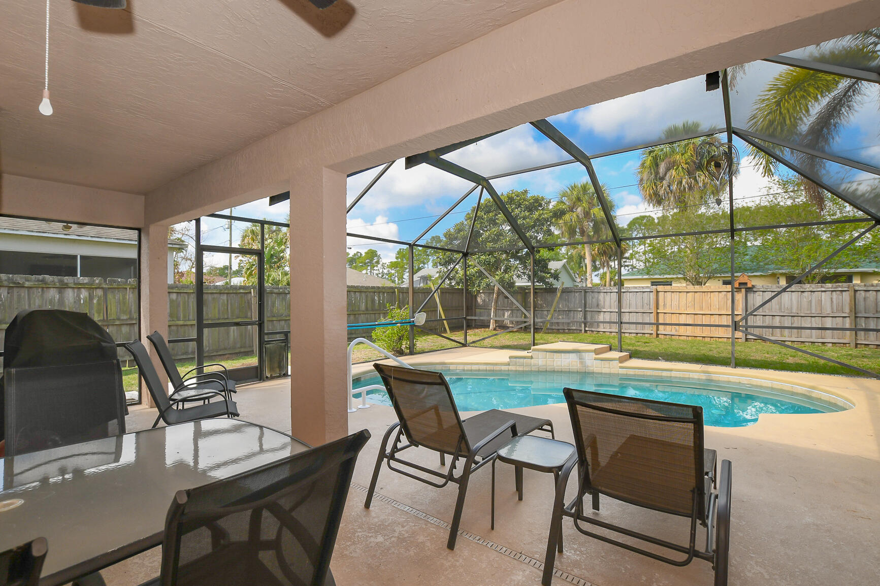1662 Southwest Rutland Street Port St. Lucie, FL 34987 - Photo 8 of 40 a dining room with furniture and a floor to ceiling window