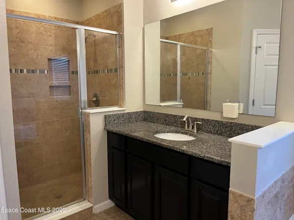 a bath tub sitting in a bathroom next to a sink