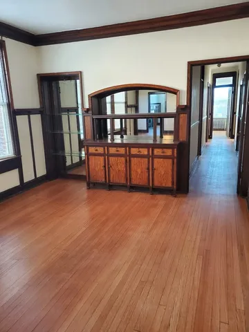 a big room with wooden floor and windows