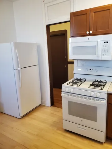 a stove top oven sitting inside of a kitchen