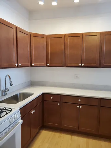 a kitchen with a sink cabinets and window
