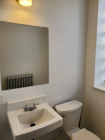 a white toilet sitting next to a bathroom sink