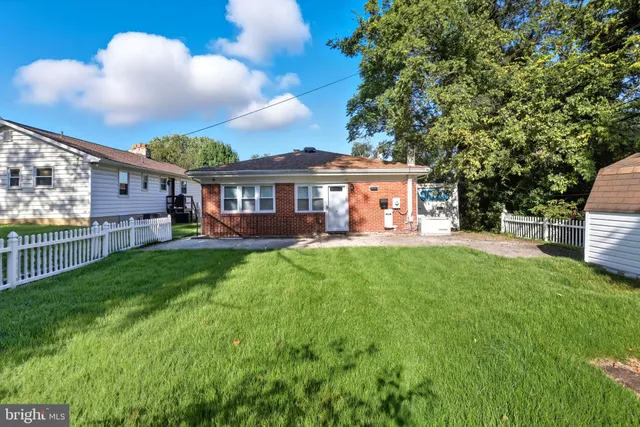 a view of a house with a backyard and a patio
