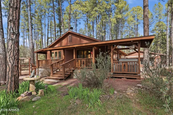 a front view of a house with yard and sitting area