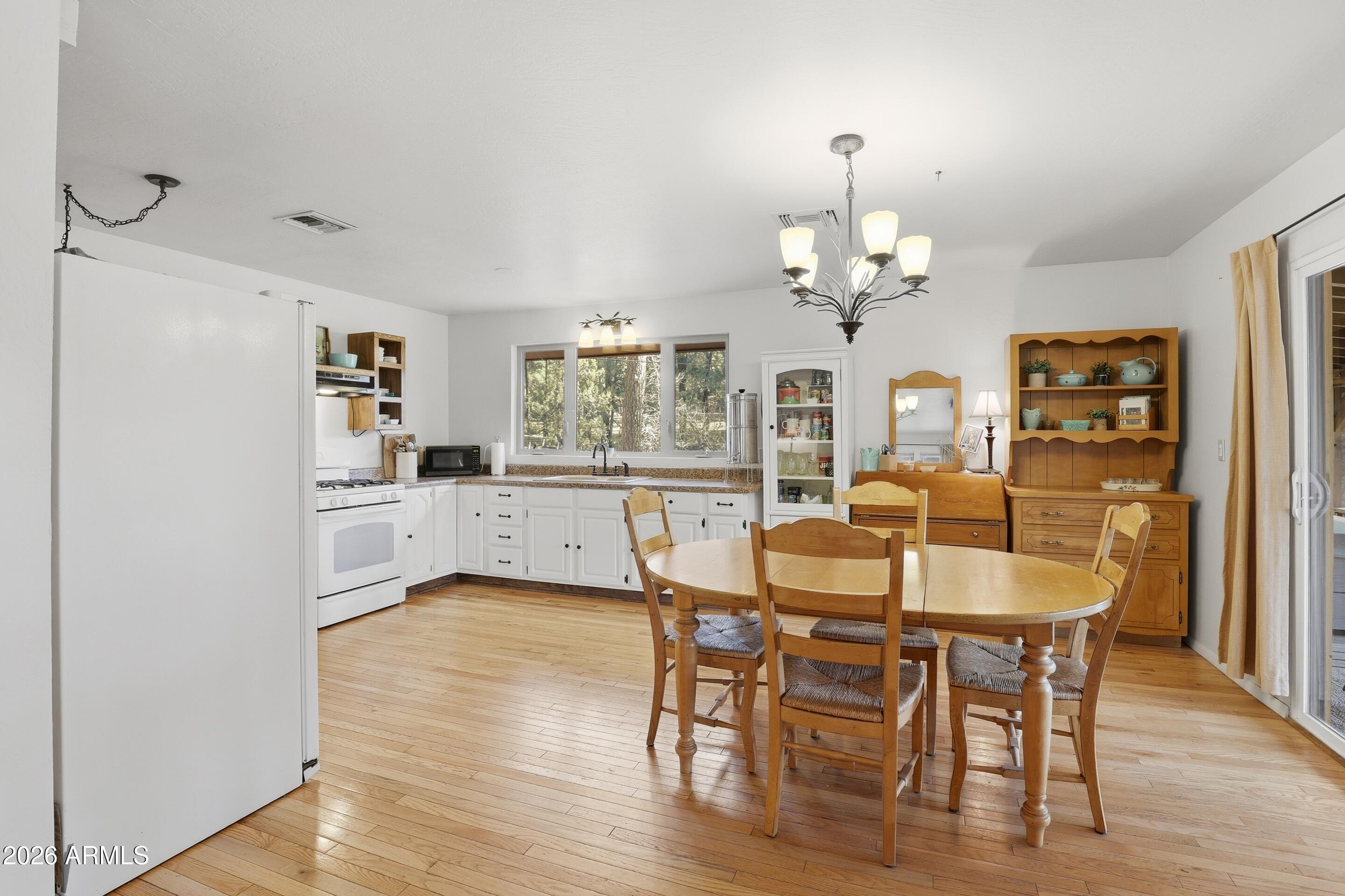 5920 Robin Way Pine, AZ 85544 - Photo 12 of 55 a view of a dining room with furniture and wooden floor