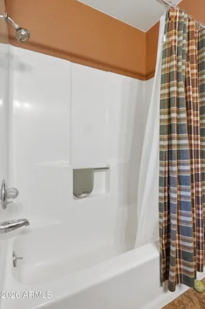a bathroom with a bathtub and shower