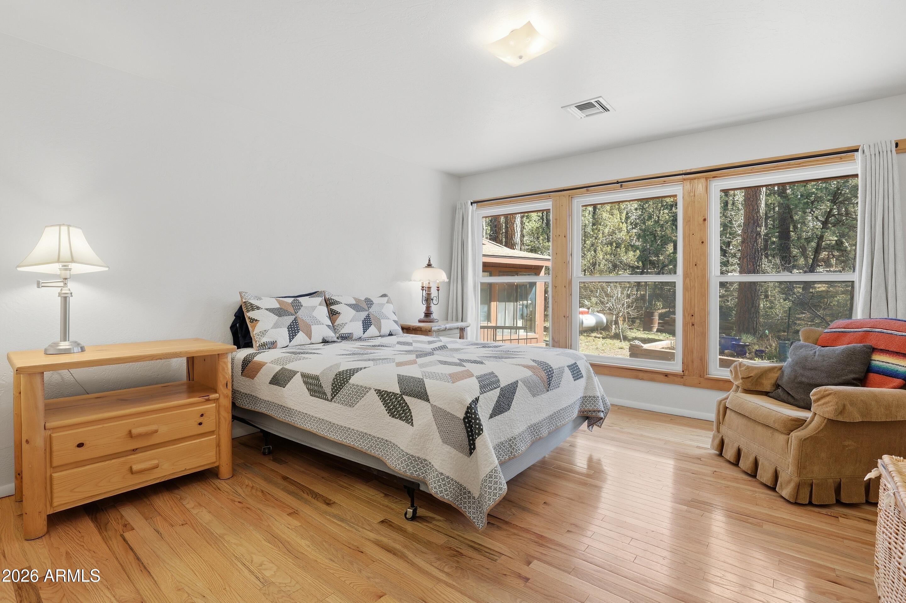 5920 Robin Way Pine, AZ 85544 - Photo 17 of 55 a spacious bedroom with a bed and a couch