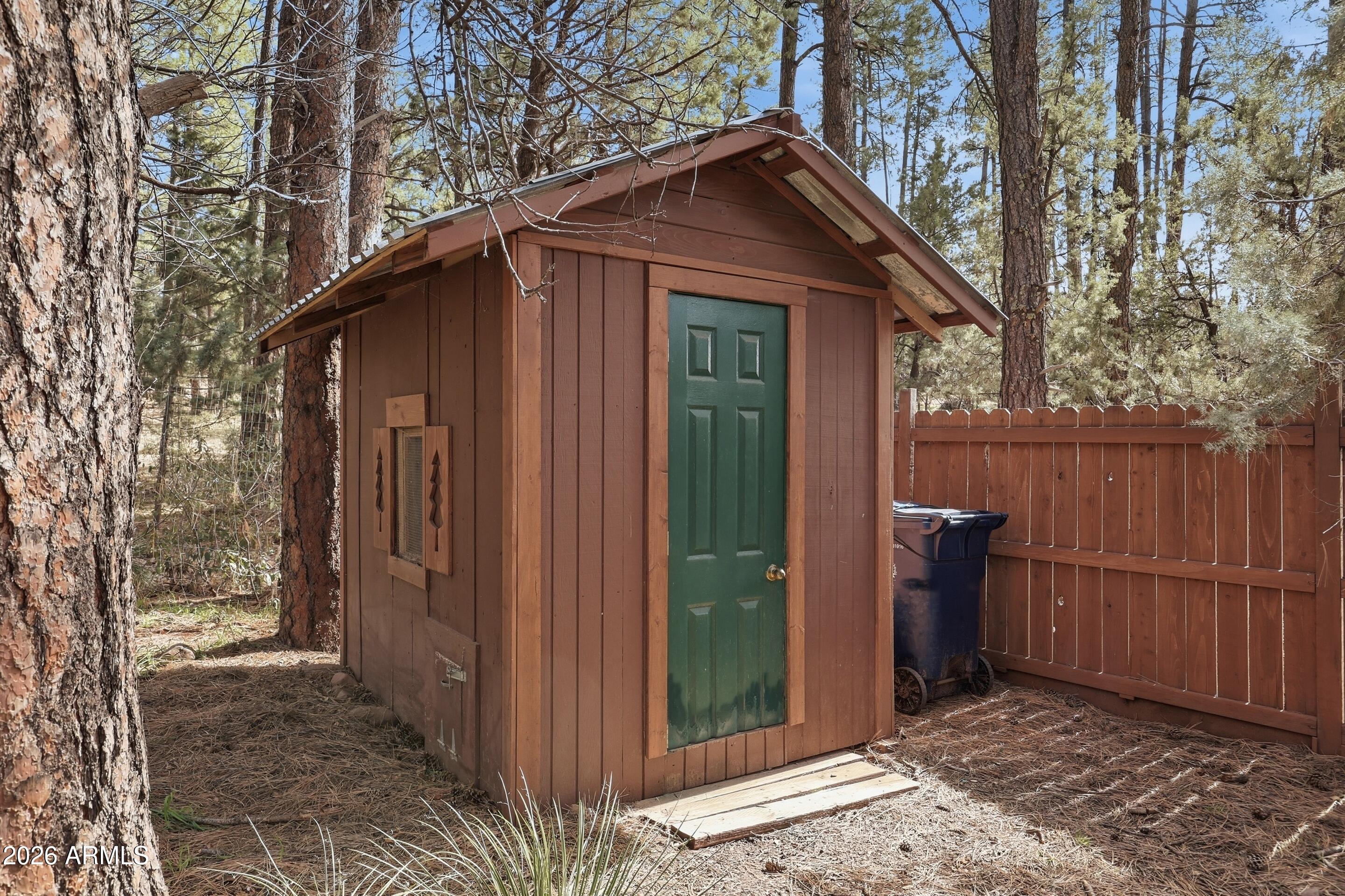 5920 Robin Way Pine, AZ 85544 - Photo 29 of 55 a view of wooden house with a small yard and wooden fence