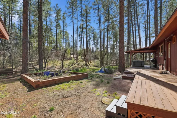 a backyard of a house with barbeque oven and outdoor seating