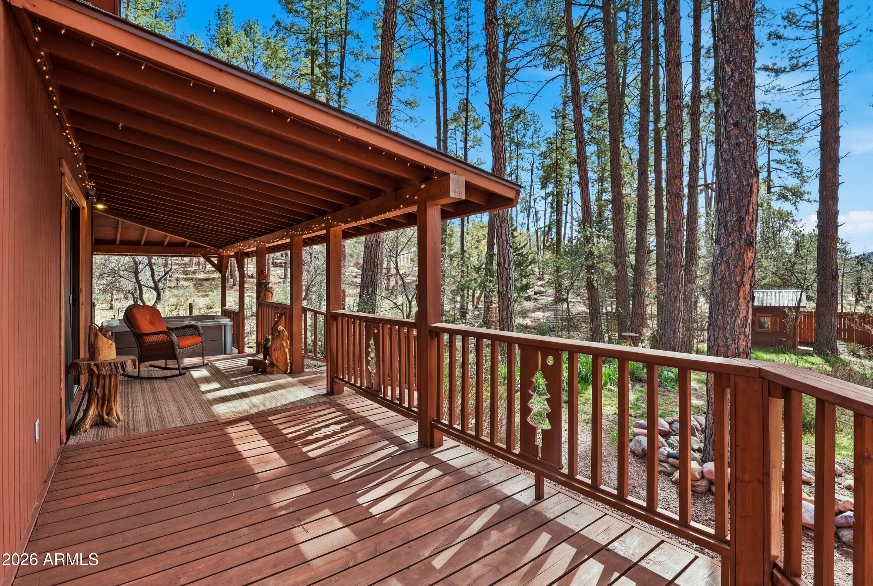 5920 Robin Way Pine, AZ 85544 - Photo 52 of 55 a balcony with wooden floor outdoor seating and yard in the back