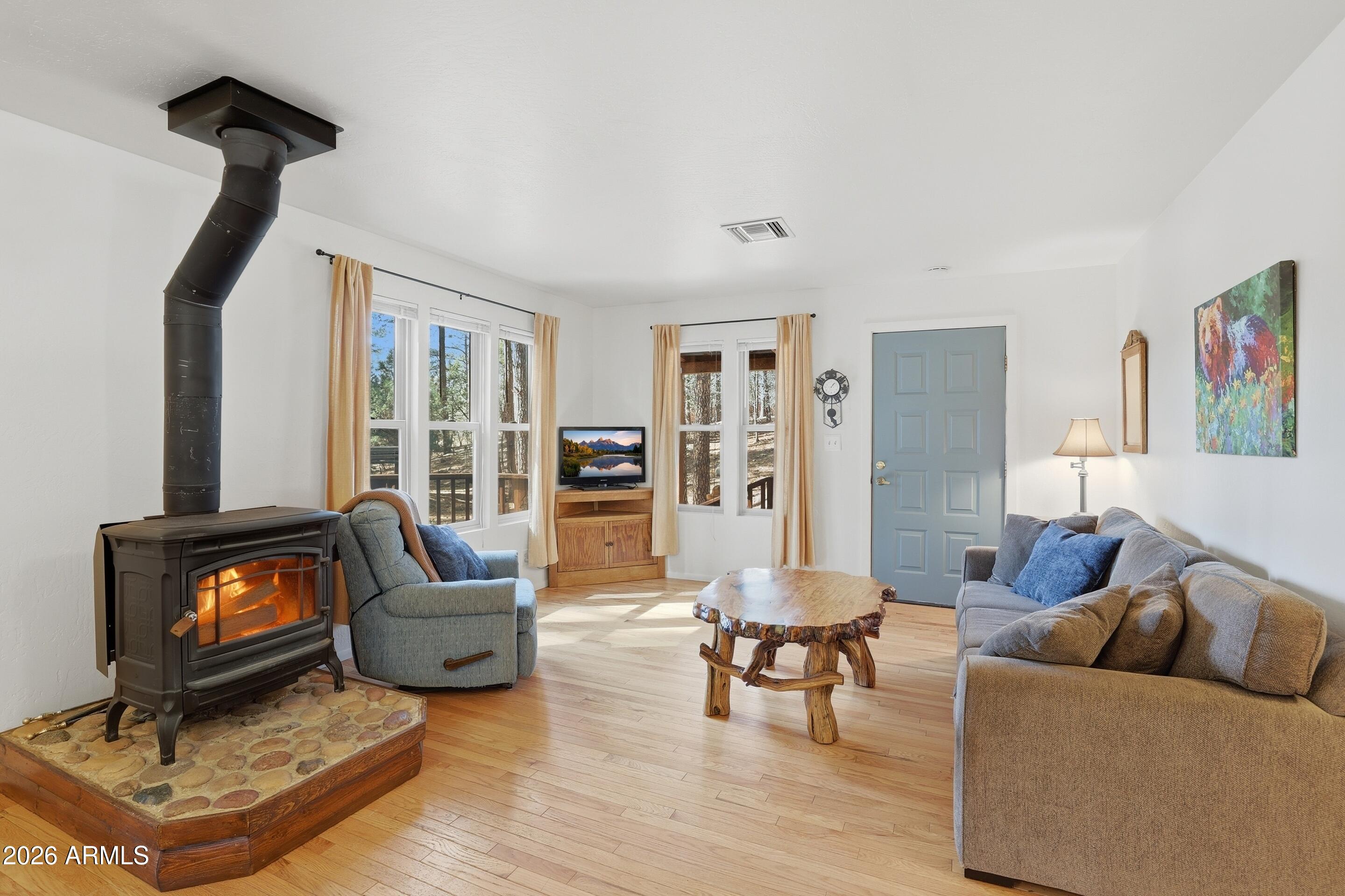 5920 Robin Way Pine, AZ 85544 - Photo 7 of 55 a living room with furniture and a fireplace