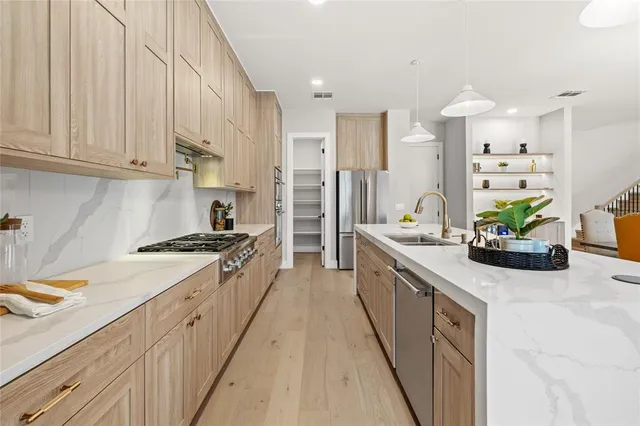 a kitchen with granite countertop a stove and a refrigerator