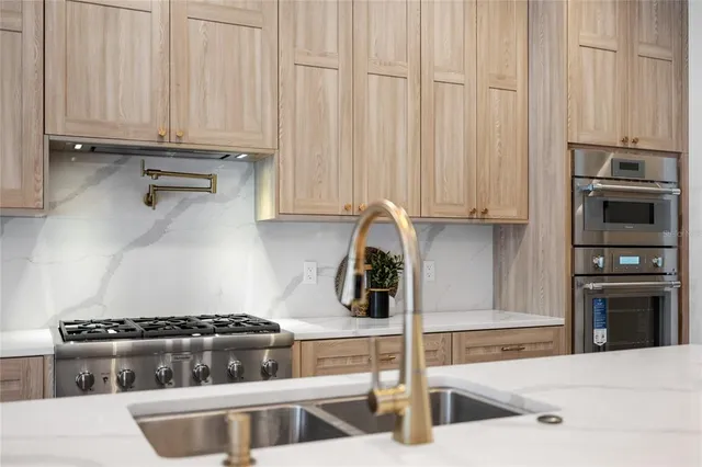 a kitchen with granite countertop a stove and a sink