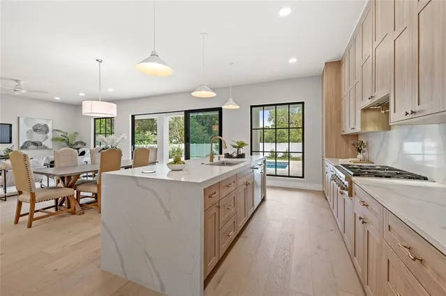 a living room with furniture potted plant and a large window