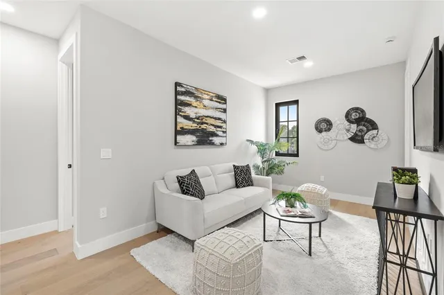 a bedroom with a bed flat screen tv and a window