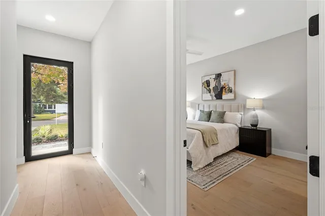 a bedroom with a bed and a painting on the wall