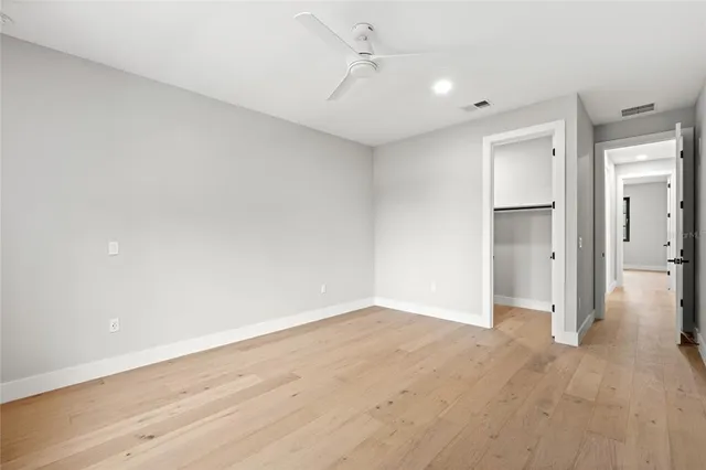 a view of backyard with large trees and plants