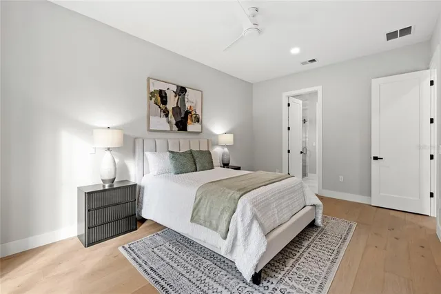 a spacious bedroom with a bed and a window