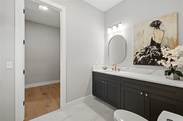 a kitchen with stainless steel appliances kitchen island granite countertop a sink a stove and a refrigerator