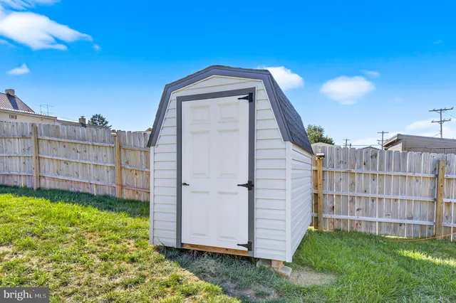 a view of a backyard with a small cabin