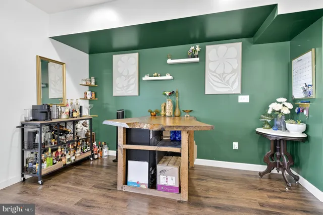a view of a room with furniture and wooden floor