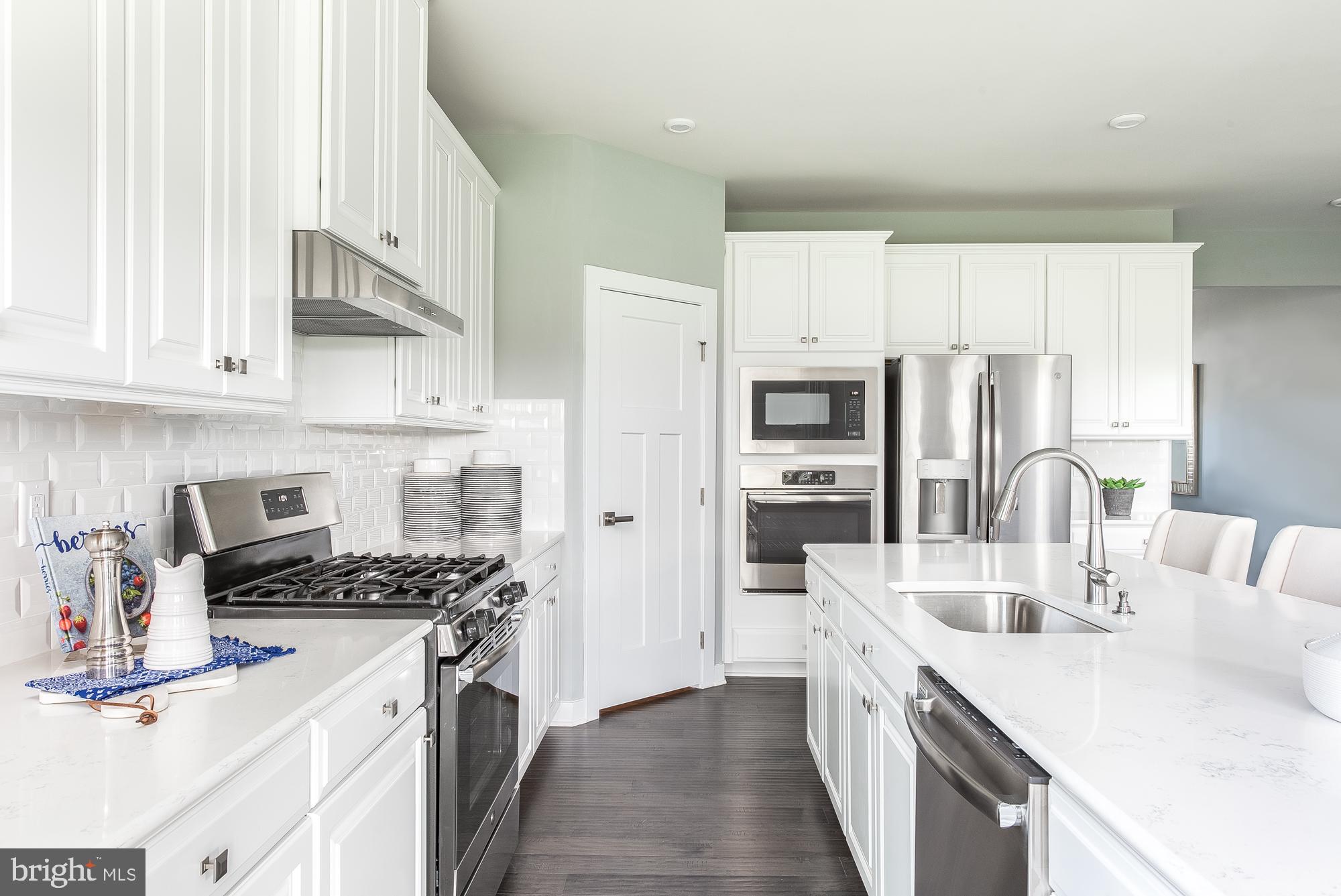 48 Wallace Way Ranson, WV 25438 - Photo 4 of 15 a kitchen with stainless steel appliances granite countertop a sink stove and refrigerator
